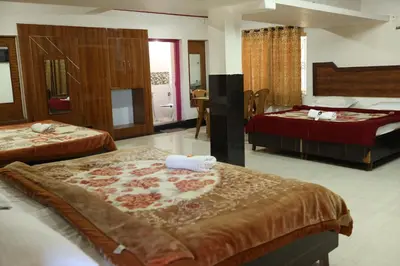 a hotel room with two beds in a room at Hotel Sri Balaji in Ooty