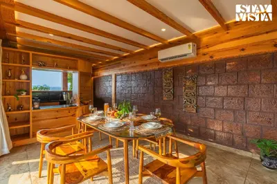 a dining room with a table and chairs at StayVista at Exotica Kabini - All Meals Included - Riverfront Villa in Antarasante