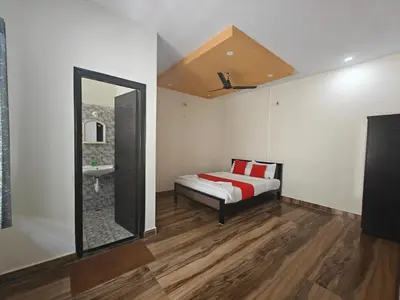 a bedroom with a bed and a mirror at The Whispering Willows in Mysore