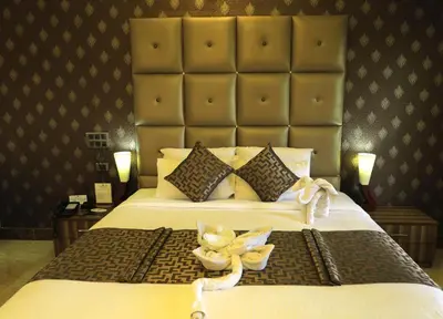 a bedroom with a large bed with flowers on it at Jal Mahal Resort and Spa in Mysore