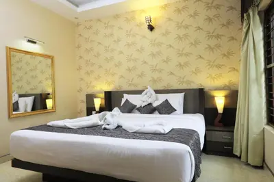 a bedroom with a large bed with towels on it at Jal Mahal Resort and Spa in Mysore