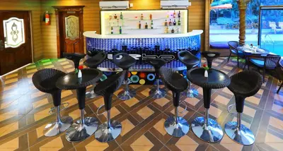 a group of stools in a room with a counter at Jal Mahal Resort and Spa in Mysore