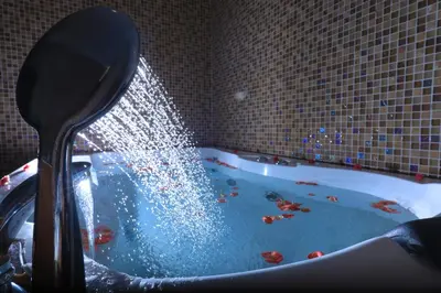 a bath tub filled with water with a spoon at Jal Mahal Resort and Spa in Mysore