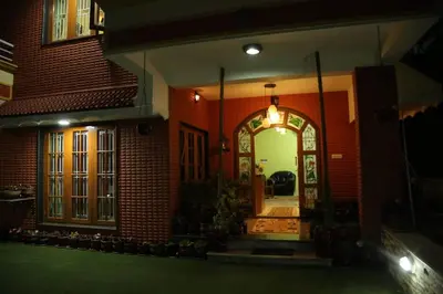 a house with an archway in the front of it at Madhu Manish Homestay and Rooms in Coonoor
