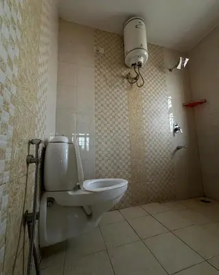 a bathroom with a toilet and a shower at Madhu Manish Homestay and Rooms in Coonoor
