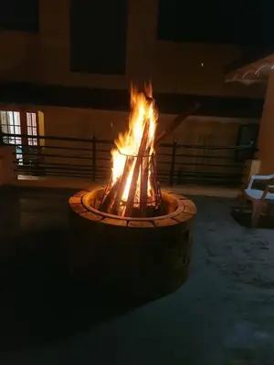 a fire pit in a courtyard at night at Madhu Manish Homestay and Rooms in Coonoor