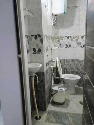 a bathroom with a toilet and a sink at Vigneshwara Nilaya in Mysore