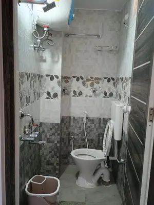 a bathroom with a toilet and a sink at Vigneshwara Nilaya in Mysore