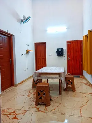 a room with a table and two red doors at Centre Home Homestay Wayanad in Kalpetta