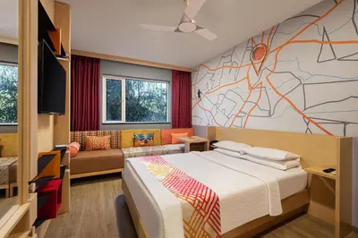 a bedroom with a bed and a wall with a map at Ginger Coimbatore Airport , Avinashi Road in Coimbatore