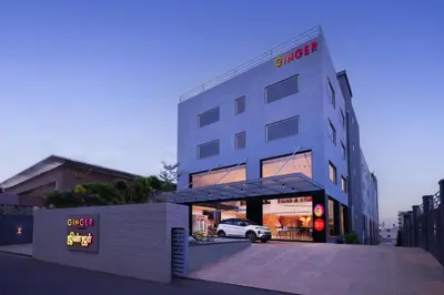 a building with a car parked in front of it at Ginger Coimbatore Airport , Avinashi Road in Coimbatore