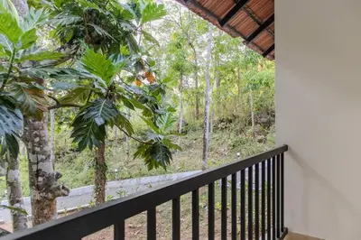 a balcony with a view of the forest at Peechi Green Valley in Pattikad