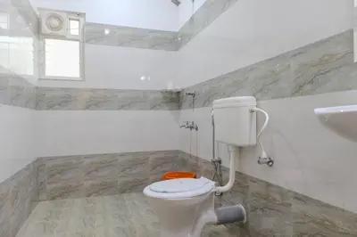 a bathroom with a white toilet and a sink at Peechi Green Valley in Pattikad