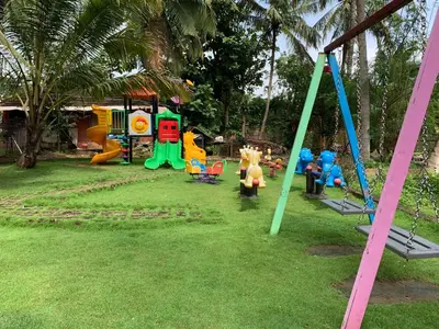 a playground with a bunch of play equipment at Udaya Resort in Palakkad
