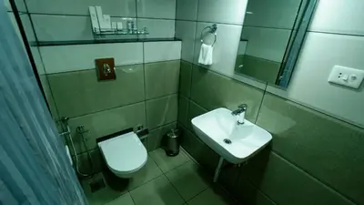 a bathroom with a toilet and a sink at Carmel Top Munnar in Munnar