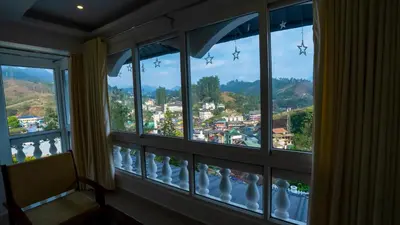a room with a window with white vases at Carmel Top Munnar in Munnar