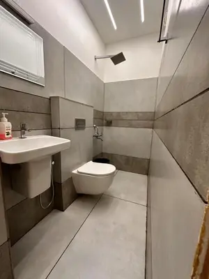 a bathroom with a toilet and a sink at Grandstaykannur in Kannur