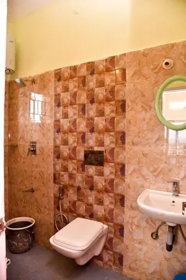 a bathroom with a toilet and a sink at Phoenix View Stay Ooty in Ooty