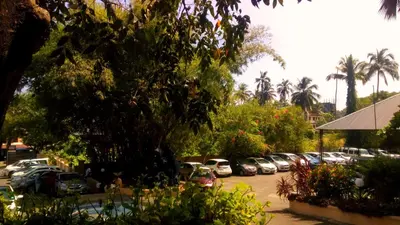 a group of cars parked in a parking lot at Sopanam Heritage in Guruvāyūr