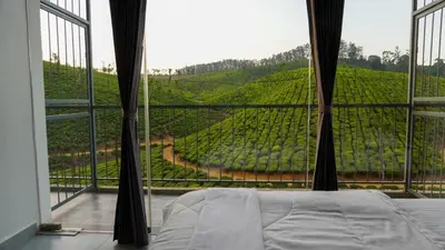 a bedroom with a large window looking at a vineyard at Zen Vista in Vālpārai