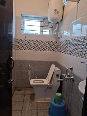 a small bathroom with a toilet and a sink at Royal homes a1 in Kushālnagar