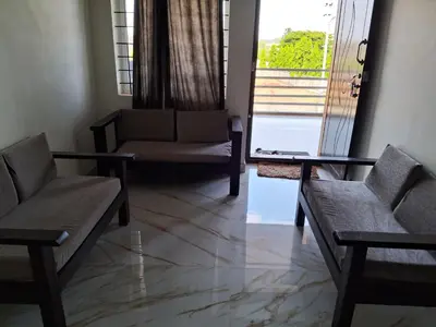 a living room with two chairs and a couch at Royal homes a1 in Kushālnagar