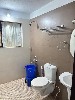 a bathroom with a toilet and a sink at Vilayara Heritage Retreat in Kunnamangalam