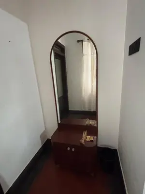 a bathroom with a mirror and a wooden sink at Vilayara Heritage Retreat in Kunnamangalam
