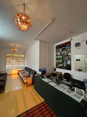 a room with a bar with a couch and a bar at Red Stone Villas in Madikeri