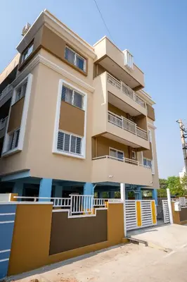 a building with balconies in front of it at Elegance Serviced Apartment in Mysore