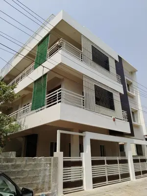 a building with white and green balconies on it at ORCHID ELITE BRINDAVAN in Mysore