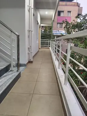 a corridor of a building with a walkway at ORCHID ELITE BRINDAVAN in Mysore