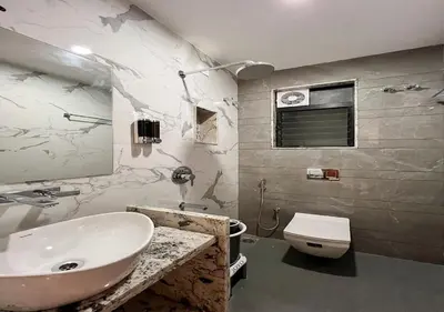 a bathroom with a sink and a toilet at J Square Inn in Coimbatore