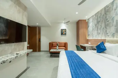 a hotel room with a bed and a couch at J Square Inn in Coimbatore