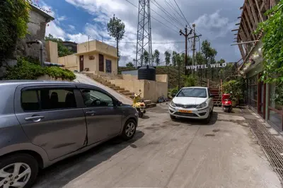 two cars parked on the side of a dirt road at WINTEL WILD in Vālpārai