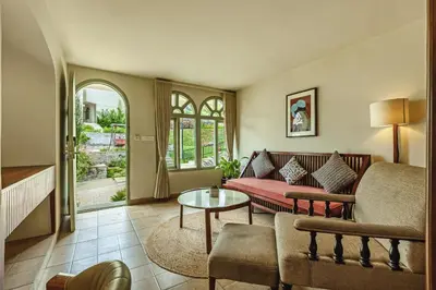 a living room with a couch and a table at Mango Hill Shola Ooty in Ooty