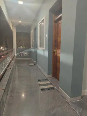 an empty room with a hallway with a door at JP Residency, near to Isha, Adhiyogi & Karunya in Alāndurai