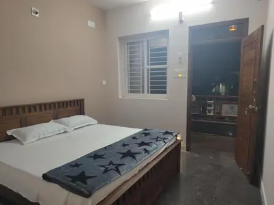 a bedroom with a large bed with stars on it at JP Residency, near to Isha, Adhiyogi & Karunya in Alāndurai