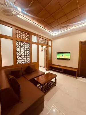 a living room with a couch and a tv at Fortune Hills in Palakkad