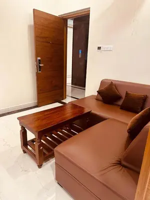 a living room with a couch and a wooden table at Fortune Hills in Palakkad