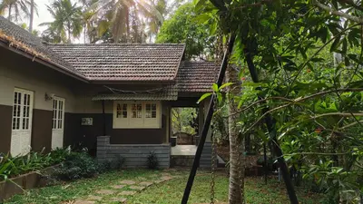 a small house with a gate in front of it at Diya's Estate Stay in Thamarassery