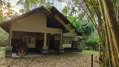 a small house in the middle of a forest at Diya's Estate Stay in Thamarassery