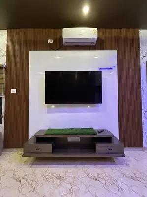 a flat screen tv on a wall in a room at Bhoomiputra Mansion in Mysore