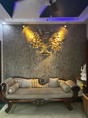 a couch sitting against a brick wall with lights on it at Bhoomiputra Mansion in Mysore