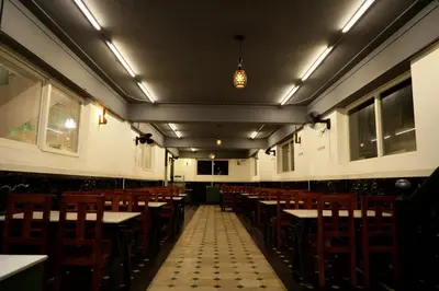 an empty dining room with tables and chairs at HILL PALACE RESIDENCY COORG in Virajpet