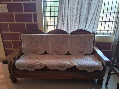 a couch sitting in front of a window at Royal homes a5 in Kushālnagar