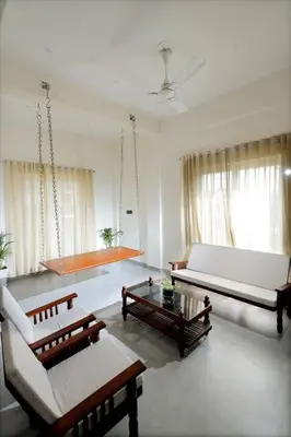 a living room with two couches and a table at Eazy Homes in Palakkad