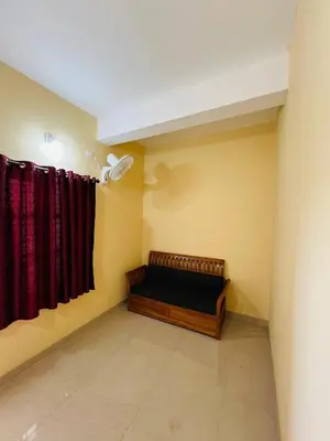 a room with a bed and red curtains at Rivera Holiday Home in Vythiri