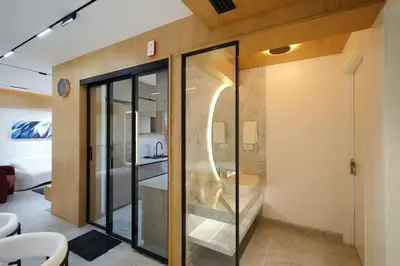 a bathroom with a glass shower and a toilet at The Nova Heights in Kozhikode