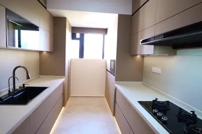 a kitchen with a sink and a refrigerator at The Nova Heights in Kozhikode